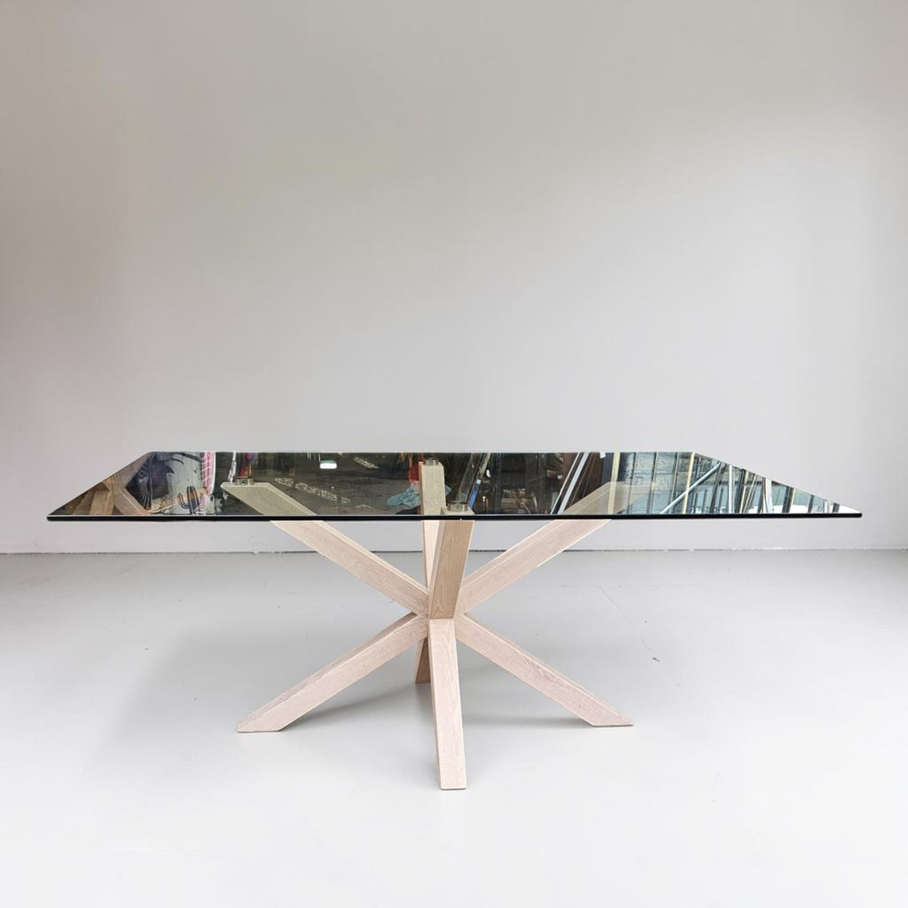 Wooden Table With A Glass Top Paired With Six White Metal And Wood Dining Chairs