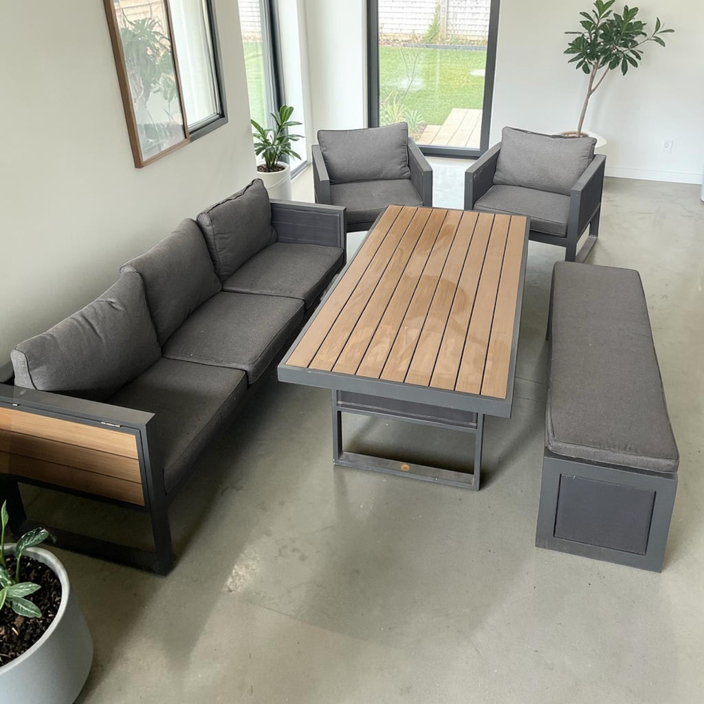 Grey Patio Lounge Set With Charcoal Cushions And A Slatted Wood-Top Rising Table