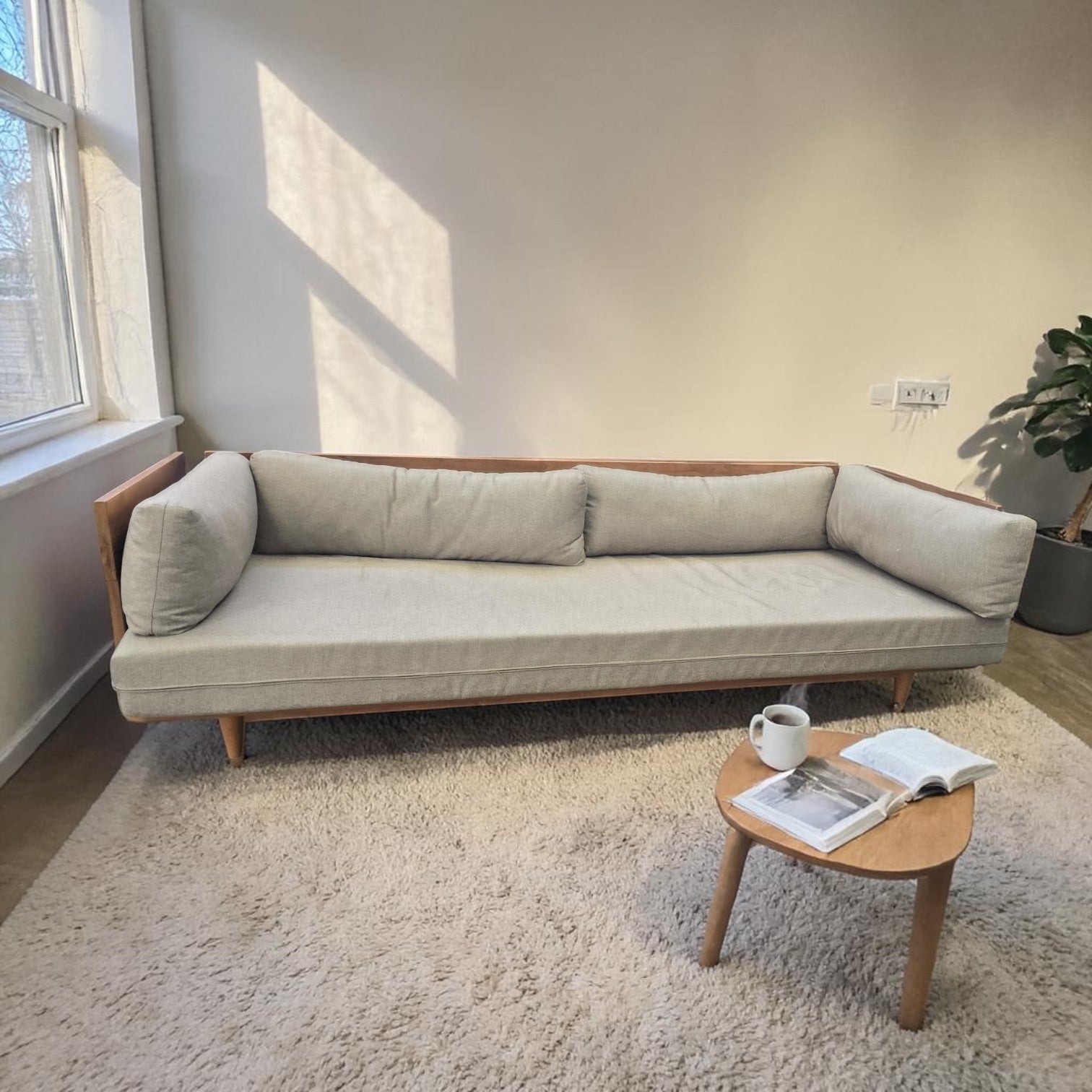 Modern Scandinavian Style Sofa Bed With A Light Wood Frame And Grey Upholstered Cushions X2 ($1300 Each)